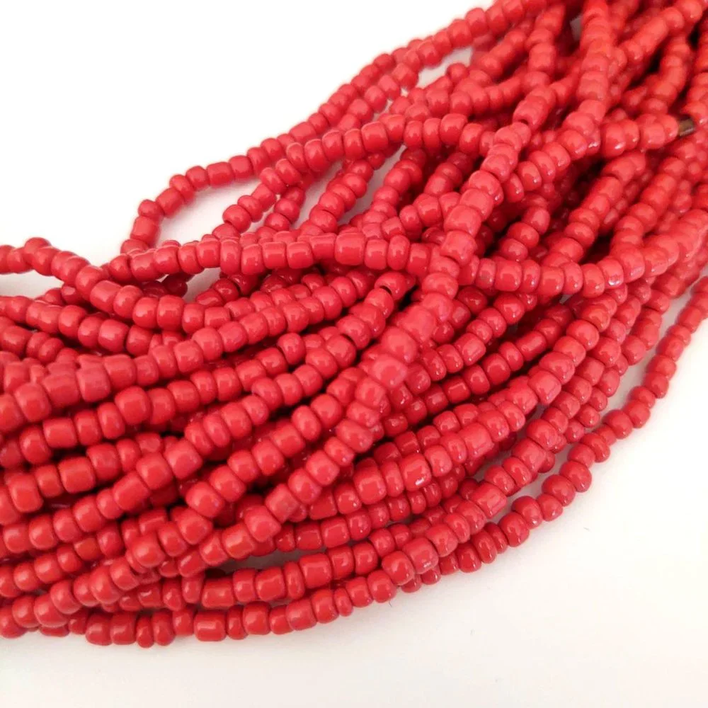 Layered orange beaded necklace with old coin toggle closure